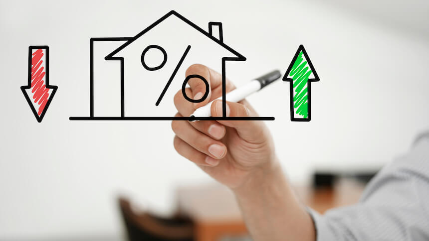 Whiteboard drawing of house with interest rate arrows